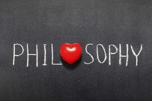 philosophy word handwritten on chalkboard with heart symbol instead of O