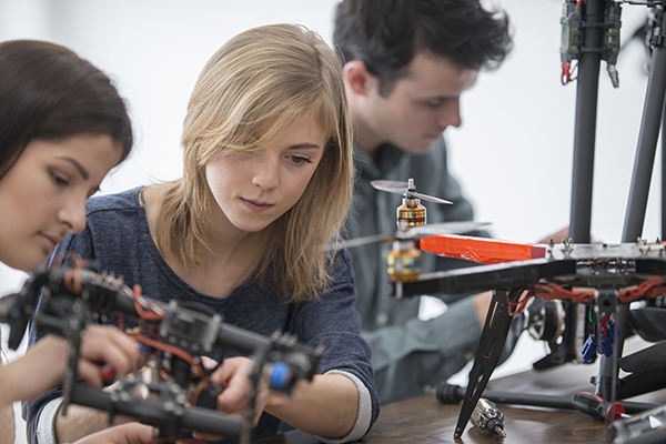 University students at a tech college working on robotic drones as part of their science project.