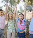 “Teachers who listen to us and our children, are key to successful learning,” say IB parents Girls with arms raised