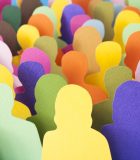 The fluid identity of a cultural-other Lots of multicolored men and women silhouettes made with paper for crowd concept