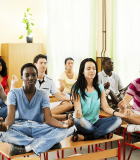 iStock_Group_Students_Meditating_on_Desk_Large