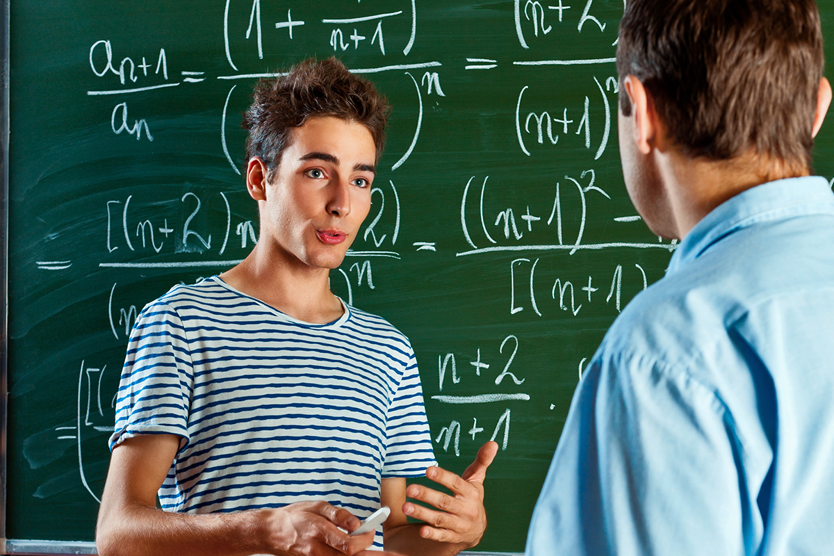 iStock_Male_Student_Explaining_Maths_Blackboard_Double