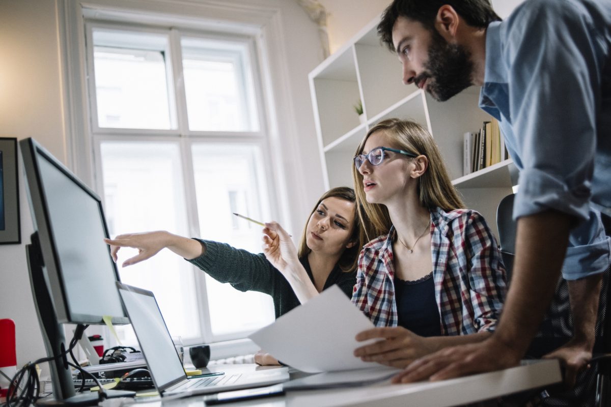 Young teammates working at office desk