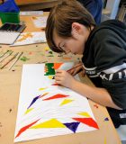 An MYP student making art inspired by light reflection 