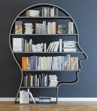 Head with a bookshelf in front of black wall