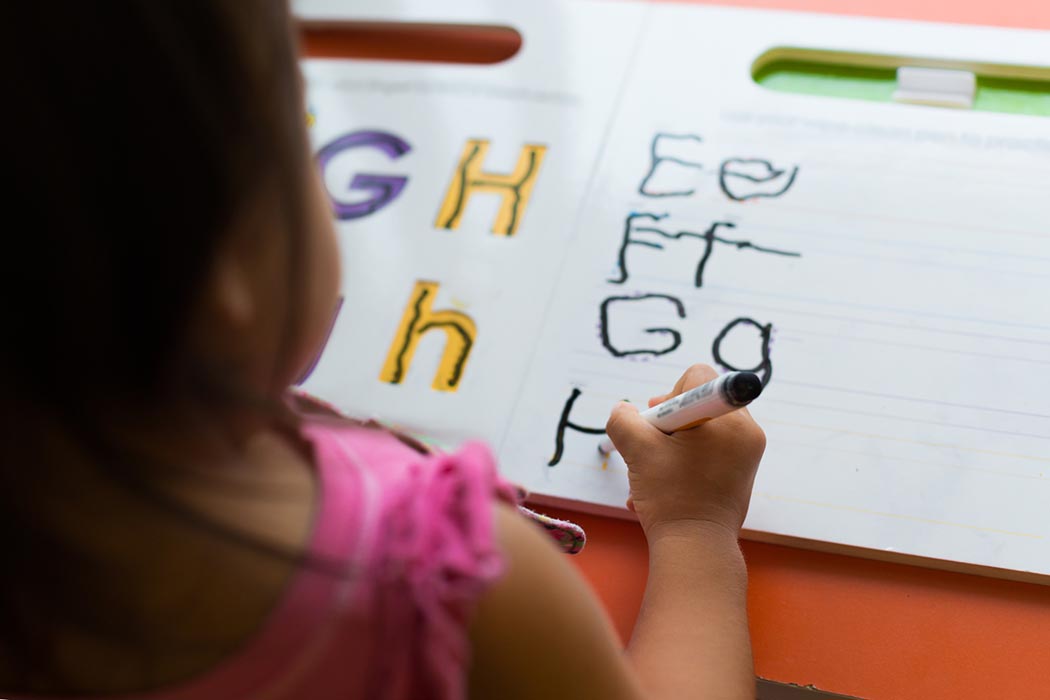 kids learning in classroom. homeschooling concept. close of tracing the alphabet