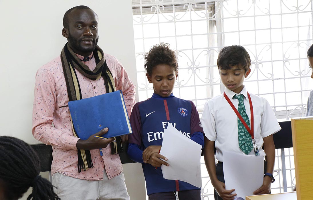 UoPeople scholarship recipient and Middle Years Programme (MYP) teacher Timoteo with his students.